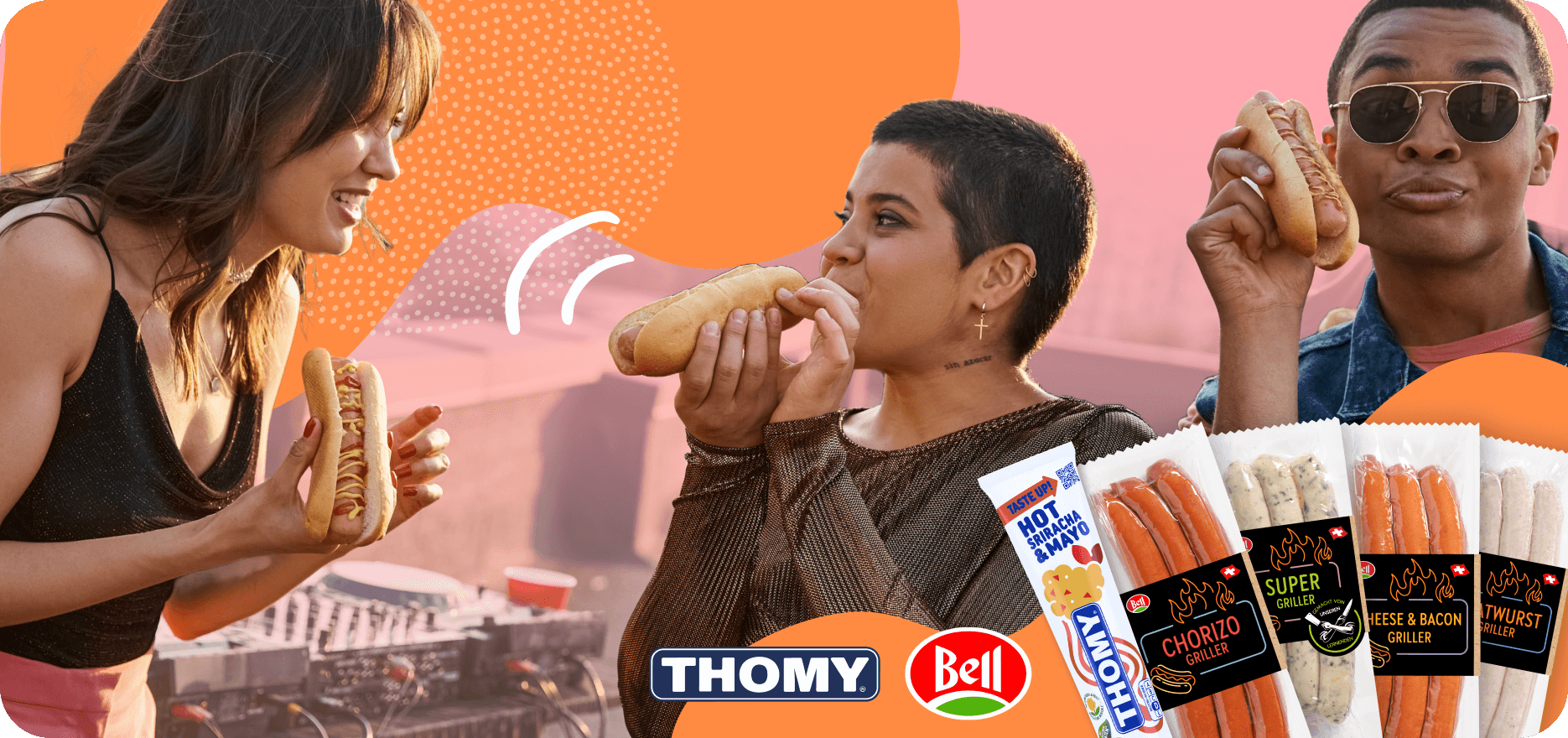 Two people enjoying hot dogs together, accompanied by a man and woman, promoting friendship with Thomy brand.
